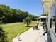 Relax on this home's beautiful back porch overlooking a large lawn with mature trees at 106 Palo Verde Dr, Leesburg, FL 34748
