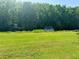 Picturesque backyard overlooking a canal with boat dock and lush greenery at 106 Palo Verde Dr, Leesburg, FL 34748
