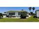 Inviting backyard featuring an outdoor patio and a well-manicured lawn at 106 Palo Verde Dr, Leesburg, FL 34748