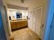 This spacious bathroom features a wooden vanity with a granite countertop and a storage closet at 106 Palo Verde Dr, Leesburg, FL 34748