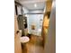Compact bathroom featuring a glass-enclosed shower, earth-tone tile floors, and vanity at 106 Palo Verde Dr, Leesburg, FL 34748