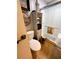 Bright bathroom features a glass enclosed shower, toilet and linen storage at 106 Palo Verde Dr, Leesburg, FL 34748