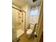 This bathroom offers a walk-in shower, toilet, grab bar, and tile floors for a clean and modern design at 106 Palo Verde Dr, Leesburg, FL 34748