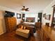 This bedroom boasts wood floors, a ceiling fan, and ample storage space with matching wooden dressers at 106 Palo Verde Dr, Leesburg, FL 34748