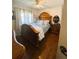 Cozy bedroom with hardwood floors, a decorative headboard, and comfortable bedding at 106 Palo Verde Dr, Leesburg, FL 34748