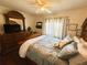 Comfortable bedroom with hardwood floors, ceiling fan and comfortable bedding at 106 Palo Verde Dr, Leesburg, FL 34748