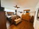 Large bedroom has hardwood floors, ceiling fan and a king size bed at 106 Palo Verde Dr, Leesburg, FL 34748