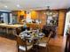 Kitchen view including a granite island with seating, bar area, and formal dining area with elegant decor at 106 Palo Verde Dr, Leesburg, FL 34748
