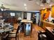 An open-concept kitchen flows into living and dining spaces, featuring a large island, stainless appliances, and bar area at 106 Palo Verde Dr, Leesburg, FL 34748