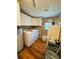 Functional laundry room with modern washer/dryer, white cabinets, and laminate flooring at 106 Palo Verde Dr, Leesburg, FL 34748