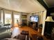Comfortable living room with hardwood floors, media center, and leather furniture at 106 Palo Verde Dr, Leesburg, FL 34748