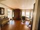 Well-lit home office with dark wood floors, classic cabinet and comfortable workspace at 106 Palo Verde Dr, Leesburg, FL 34748