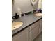 Bathroom with double vanity, grey countertops, light cabinetry and neutral walls at 1104 Illinois Ave, St Cloud, FL 34769