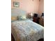 The bedroom features a wicker headboard and bright floral decor at 1104 Illinois Ave, St Cloud, FL 34769