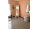 The bedroom offers a unique view with textured carpet, wicker furniture, and bright walls at 1104 Illinois Ave, St Cloud, FL 34769