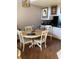 A view of dining room with a round table, seating four, on wood flooring at 1104 Illinois Ave, St Cloud, FL 34769