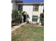 Charming townhouse featuring an inviting entrance, well-maintained lawn, and lush palm trees at 1104 Illinois Ave, St Cloud, FL 34769