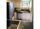 View of kitchen with stainless steel appliances, white cabinetry, and tile flooring at 1104 Illinois Ave, St Cloud, FL 34769