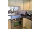 A close up view of the kitchen featuring stainless steel appliances and tile flooring at 1104 Illinois Ave, St Cloud, FL 34769