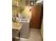 Functional laundry room features ample counter space, a utility sink, and tile flooring at 1104 Illinois Ave, St Cloud, FL 34769