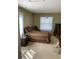 A bedroom with neutral carpeting, a bed, and natural lighting at 1134 S Pine Ridge Cir # 34, Sanford, FL 32773