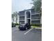 Condo exterior with multi-level screened balconies and parking area at 1134 S Pine Ridge Cir # 34, Sanford, FL 32773