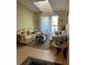 Bright living room with neutral colors, tile flooring, and sliding glass doors to a balcony at 1134 S Pine Ridge Cir # 34, Sanford, FL 32773