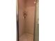 Tiled shower with glass door and built-in shelving for toiletries and personal care items at 1134 S Pine Ridge Cir # 34, Sanford, FL 32773