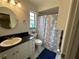 Well-lit bathroom featuring a vanity, toilet, and shower with stylish curtain at 120 Borada Rd, Sanford, FL 32773