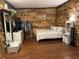 Bedroom features rustic wood accent wall with modern decor, dresser, and bed at 120 Borada Rd, Sanford, FL 32773