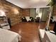 Bedroom with rustic wood panel accent wall, modern desk, and cozy seating at 120 Borada Rd, Sanford, FL 32773
