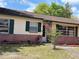 Inviting home featuring an American flag, manicured flower beds, and brick accents at 120 Borada Rd, Sanford, FL 32773