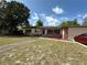 Well-kept home with lush landscaping, brick accents, and a side-entry garage at 120 Borada Rd, Sanford, FL 32773