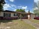 Charming single-story home with a brick facade, green shutters, and a well-maintained front yard at 120 Borada Rd, Sanford, FL 32773