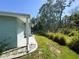 A view of the home with a manicured lawn and mature trees at 121 Bougainvillea Dr, Leesburg, FL 34748