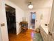 Bright bathroom featuring wood floors, a walk-in closet, and a doorway leading to the bathroom at 121 Bougainvillea Dr, Leesburg, FL 34748