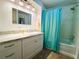 Bathroom featuring a shower-tub combination and a bright blue shower curtain at 121 Bougainvillea Dr, Leesburg, FL 34748