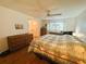 Bright bedroom featuring two dressers, a ceiling fan and an ensuite bathroom at 121 Bougainvillea Dr, Leesburg, FL 34748
