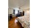 Bedroom with light colored walls, wood-look floors, ceiling fan, desk and walk in closet at 121 Bougainvillea Dr, Leesburg, FL 34748
