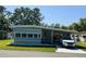 Charming single-story home featuring a carport, well-maintained lawn, and light blue siding at 121 Bougainvillea Dr, Leesburg, FL 34748