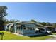 Well-maintained single-story home with a carport, lush lawn, and serene surroundings at 121 Bougainvillea Dr, Leesburg, FL 34748