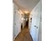 Hallway with laminate floors and white doors, leading to a bedroom at 121 Bougainvillea Dr, Leesburg, FL 34748