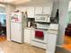 Well-equipped kitchen with white appliances, modern backsplash, and plenty of counter space at 121 Bougainvillea Dr, Leesburg, FL 34748