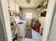 Functional laundry room with washer, dryer, sink, and storage shelves for organized convenience at 121 Bougainvillea Dr, Leesburg, FL 34748