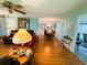 Bright living room with wood floors, stylish furniture, and an open view to the dining area at 121 Bougainvillea Dr, Leesburg, FL 34748