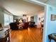 Inviting living room with wood floors, comfortable seating, and an open layout at 121 Bougainvillea Dr, Leesburg, FL 34748
