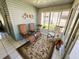 Comfortable sunroom featuring tile flooring, comfortable chairs, and great lighting at 121 Bougainvillea Dr, Leesburg, FL 34748