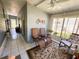 Sunroom featuring two chairs, a rocking chair, tiled floor, and a ceiling fan at 121 Bougainvillea Dr, Leesburg, FL 34748