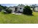 Private backyard patio with a table and chairs, great for outdoor dining and relaxation at 139 Royal Palm Dr, Leesburg, FL 34748