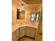 Bathroom sink vanity with tile countertops and adjacent mirror at 139 Royal Palm Dr, Leesburg, FL 34748